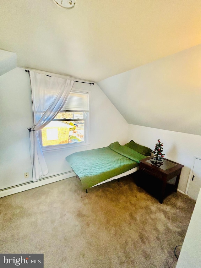 carpeted bedroom featuring a baseboard heating unit and vaulted ceiling