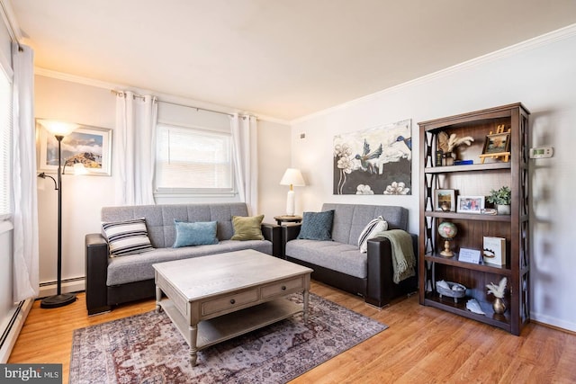 living room with a baseboard heating unit, crown molding, and light wood-style flooring