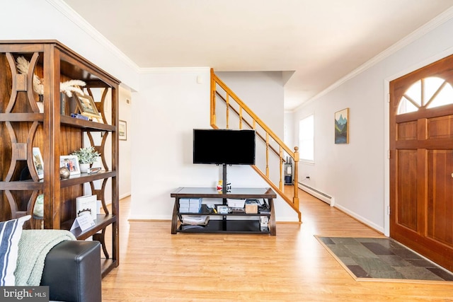 foyer with light wood-style flooring, a baseboard heating unit, crown molding, baseboards, and stairs