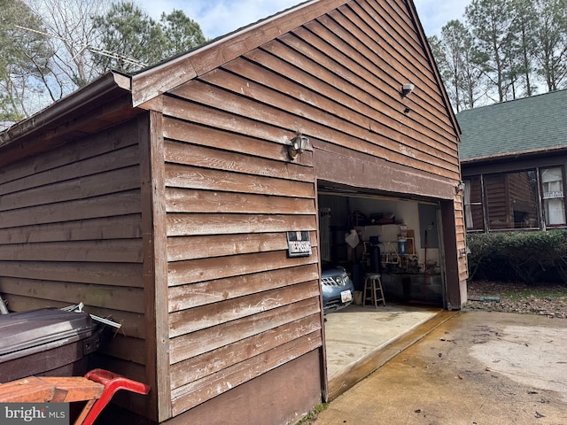 view of home's exterior featuring a garage and driveway