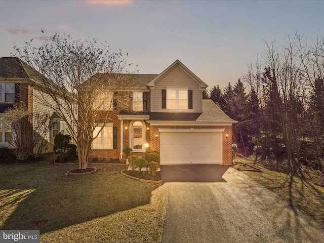 traditional-style home featuring aphalt driveway, brick siding, a shingled roof, an attached garage, and a front lawn