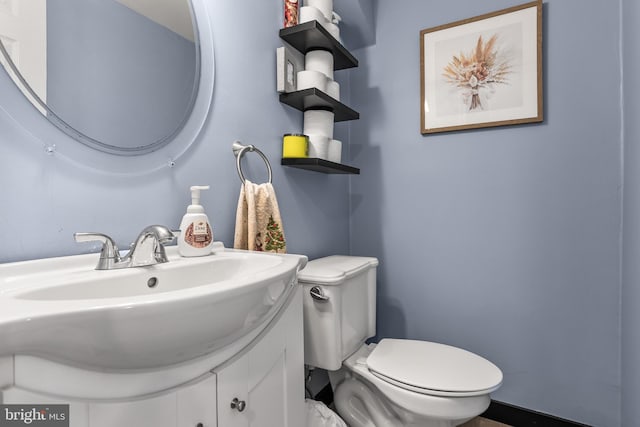 bathroom featuring toilet and vanity