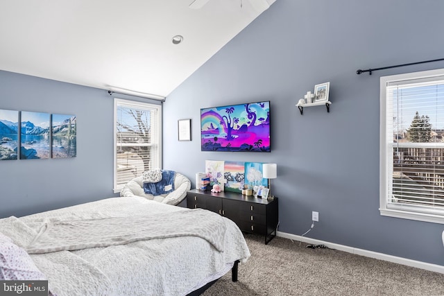 carpeted bedroom with vaulted ceiling and baseboards