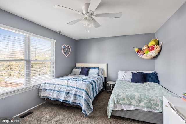 bedroom featuring visible vents, baseboards, ceiling fan, and carpet floors