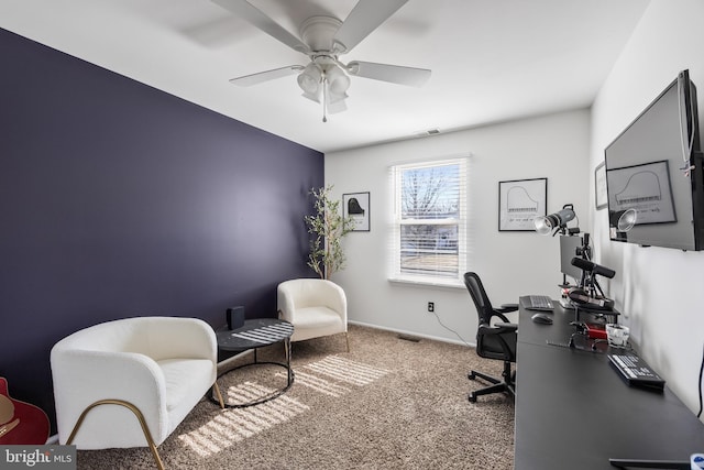 office space featuring visible vents, carpet, and a ceiling fan