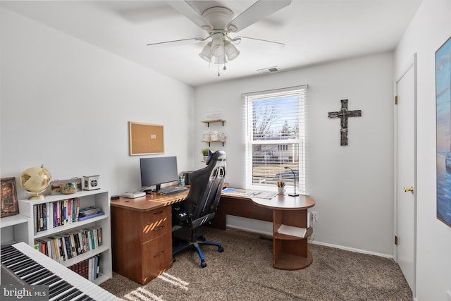 carpeted office featuring visible vents, baseboards, and ceiling fan