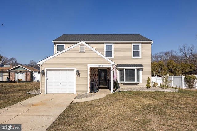 traditional home featuring a garage, driveway, a front lawn, and fence