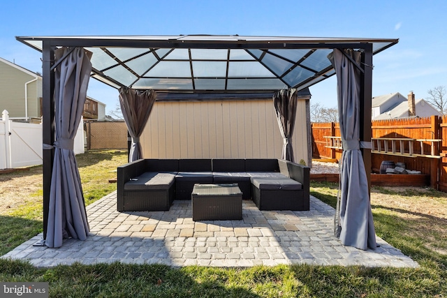 view of patio with outdoor lounge area, a gazebo, a gate, and a fenced backyard