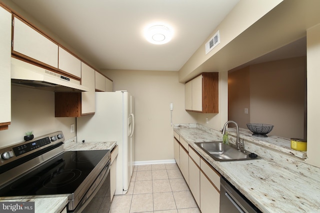 kitchen featuring visible vents, appliances with stainless steel finishes, under cabinet range hood, a sink, and light tile patterned flooring