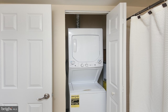 washroom with laundry area and stacked washer / drying machine