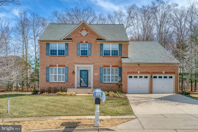 colonial-style house with a front yard, an attached garage, brick siding, and driveway