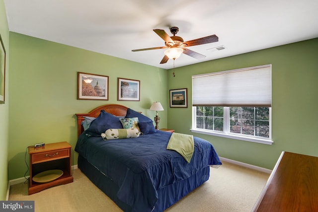 carpeted bedroom with visible vents, baseboards, and ceiling fan