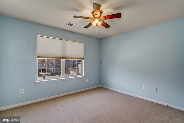 spare room featuring visible vents, a ceiling fan, baseboards, and carpet floors