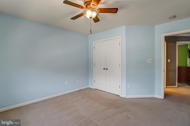 unfurnished bedroom with a ceiling fan, baseboards, a closet, and carpet floors