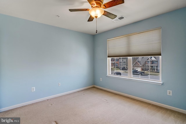 unfurnished room with carpet flooring, baseboards, and visible vents