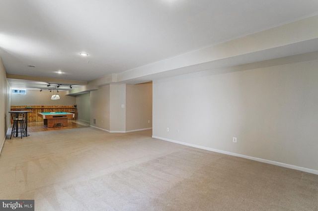 finished basement with billiards, baseboards, and light carpet