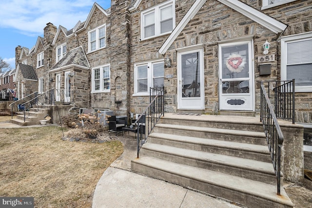 view of front of house featuring stone siding and a residential view