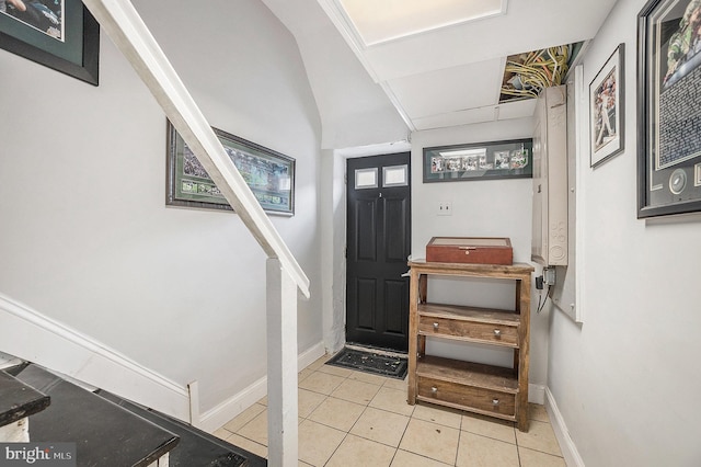 entrance foyer with baseboards and tile patterned floors