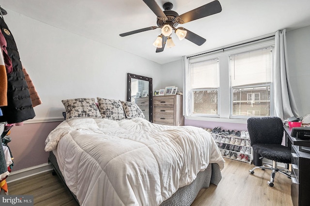 bedroom with ceiling fan and wood finished floors