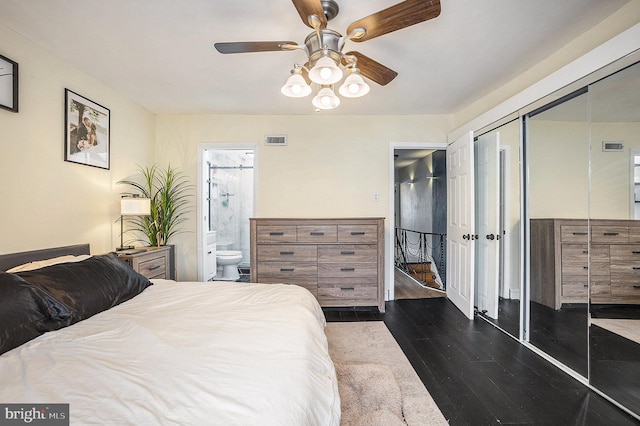 bedroom featuring connected bathroom, visible vents, a ceiling fan, a closet, and dark wood-style floors