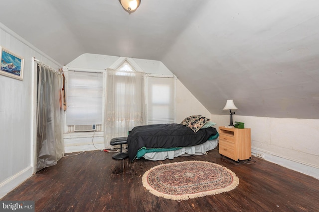 bedroom featuring vaulted ceiling, cooling unit, and wood finished floors