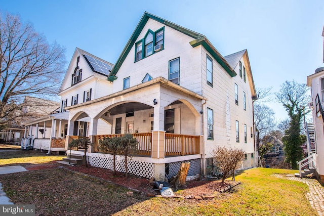 view of front of house featuring covered porch and a front yard