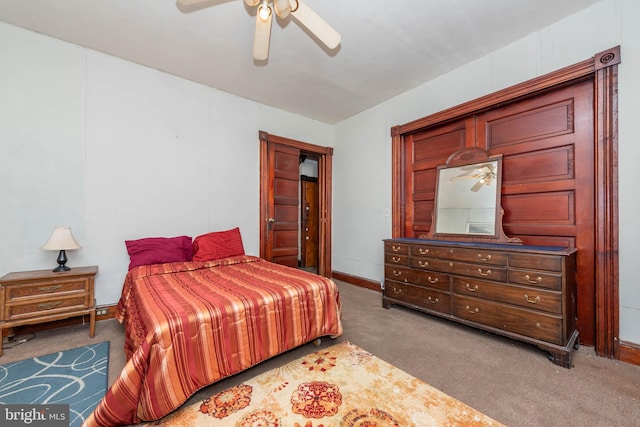 carpeted bedroom featuring baseboards and a ceiling fan