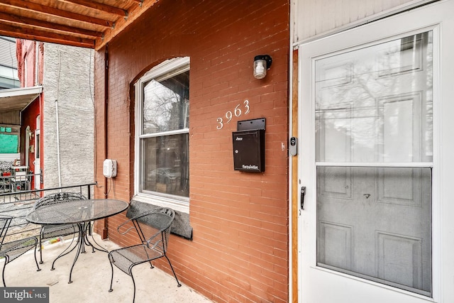 entrance to property with brick siding