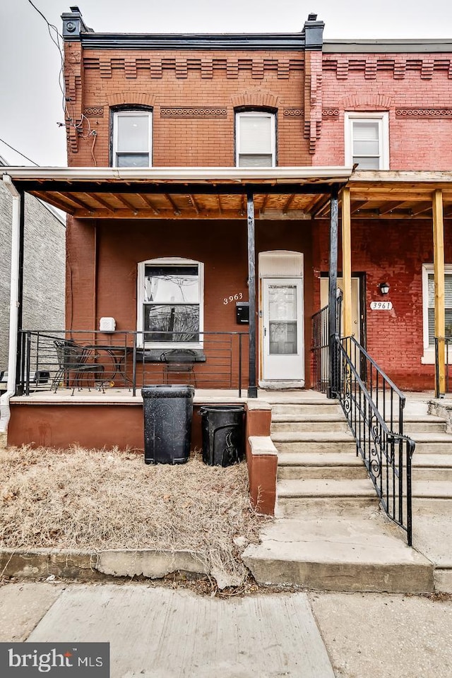 view of front of property with a porch and brick siding