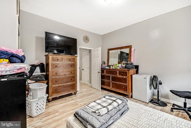 bedroom featuring wood finished floors and baseboards