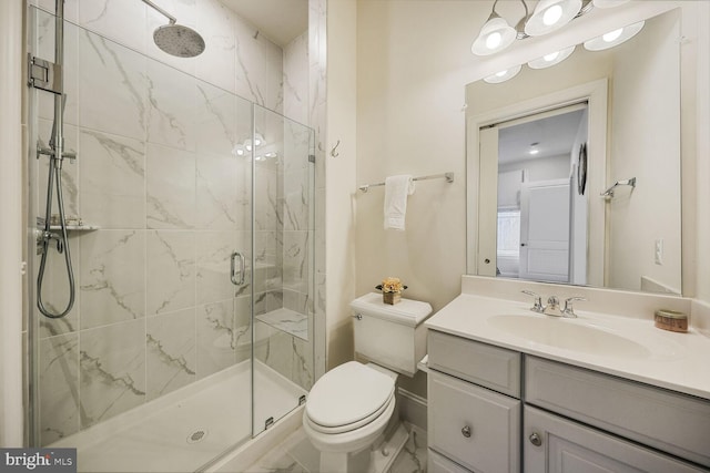 full bath featuring toilet, vanity, and a marble finish shower