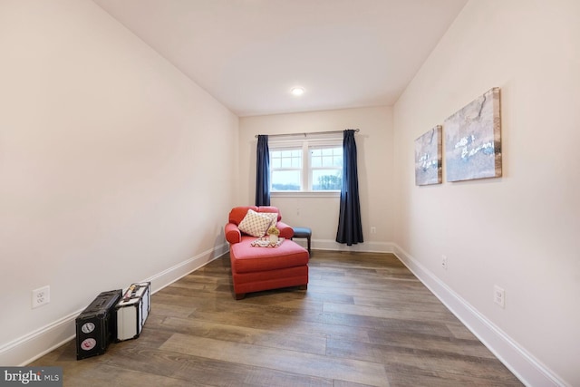 sitting room featuring baseboards and wood finished floors