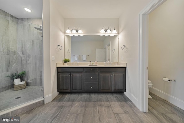 bathroom with double vanity, a sink, and a shower stall