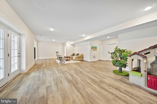 sitting room featuring baseboards, light wood-type flooring, and recessed lighting