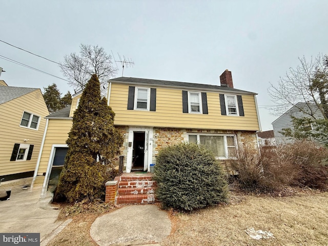 colonial-style house with a chimney