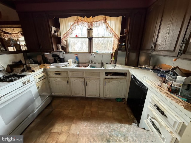 kitchen with black dishwasher, white range with gas cooktop, light countertops, and a sink