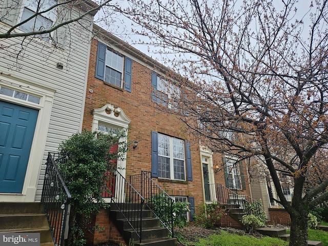 townhome / multi-family property featuring brick siding