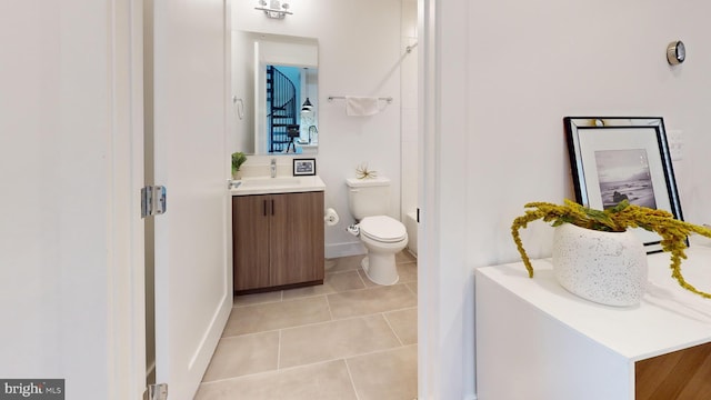 bathroom featuring tile patterned floors, toilet, and vanity