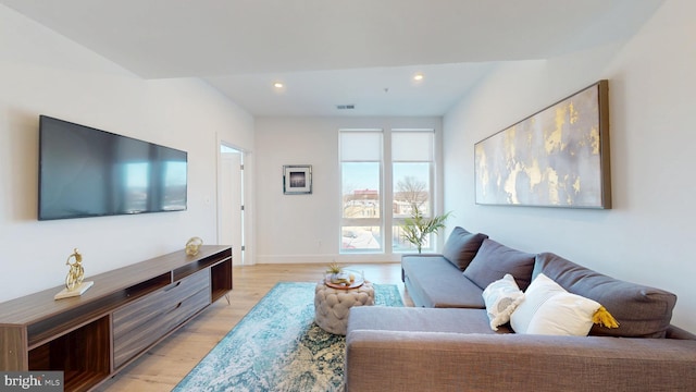 living room with visible vents, recessed lighting, light wood-type flooring, and baseboards