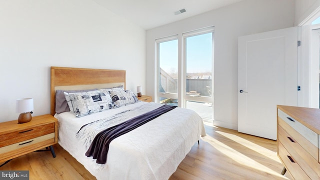 bedroom featuring light wood finished floors and visible vents