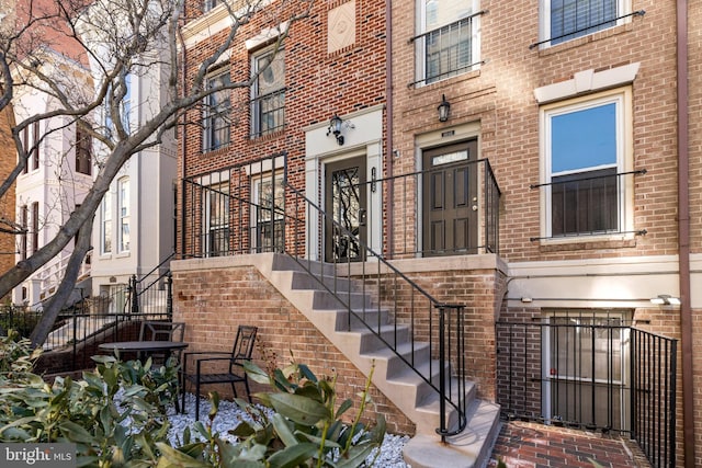 view of exterior entry with brick siding