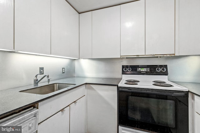 kitchen featuring dishwashing machine, white cabinets, electric stove, and a sink