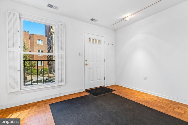 foyer with visible vents and baseboards