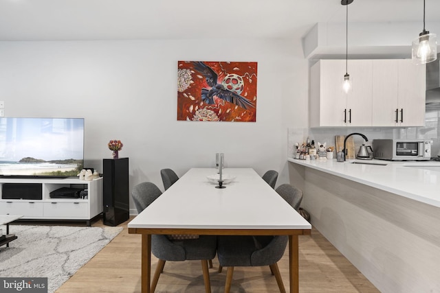 dining room featuring light wood-style flooring