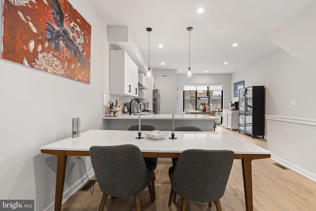 dining area with recessed lighting, wood finished floors, visible vents, and baseboards