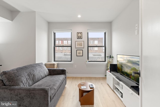 living room featuring light wood-style flooring, recessed lighting, and baseboards