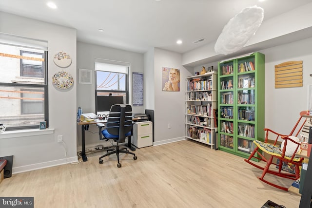 office featuring recessed lighting, visible vents, baseboards, and wood finished floors