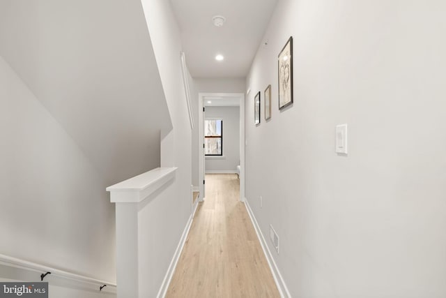 hallway featuring an upstairs landing, recessed lighting, baseboards, and light wood-type flooring