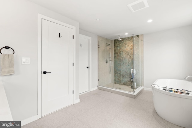 bathroom with visible vents, a shower stall, baseboards, recessed lighting, and a soaking tub