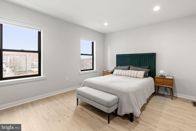 bedroom with recessed lighting, baseboards, and light wood finished floors